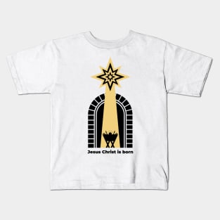 Baby Jesus in the barn, from above the light of the star of Bethlehem. Nativity of the Savior Christ. Kids T-Shirt